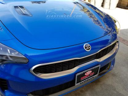 kia stinger e badge on front hood of car
