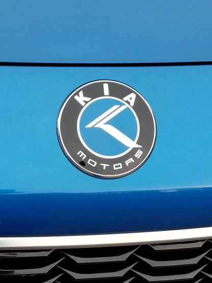 kia motors badge on blue stinger