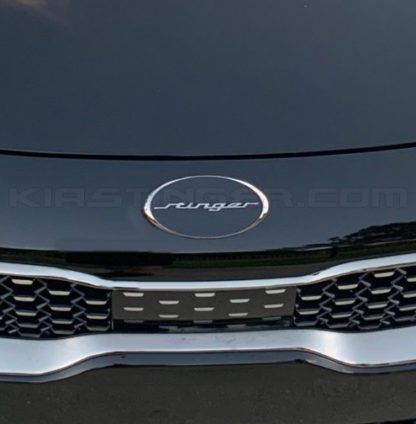 oval stinger emblem on front of kia